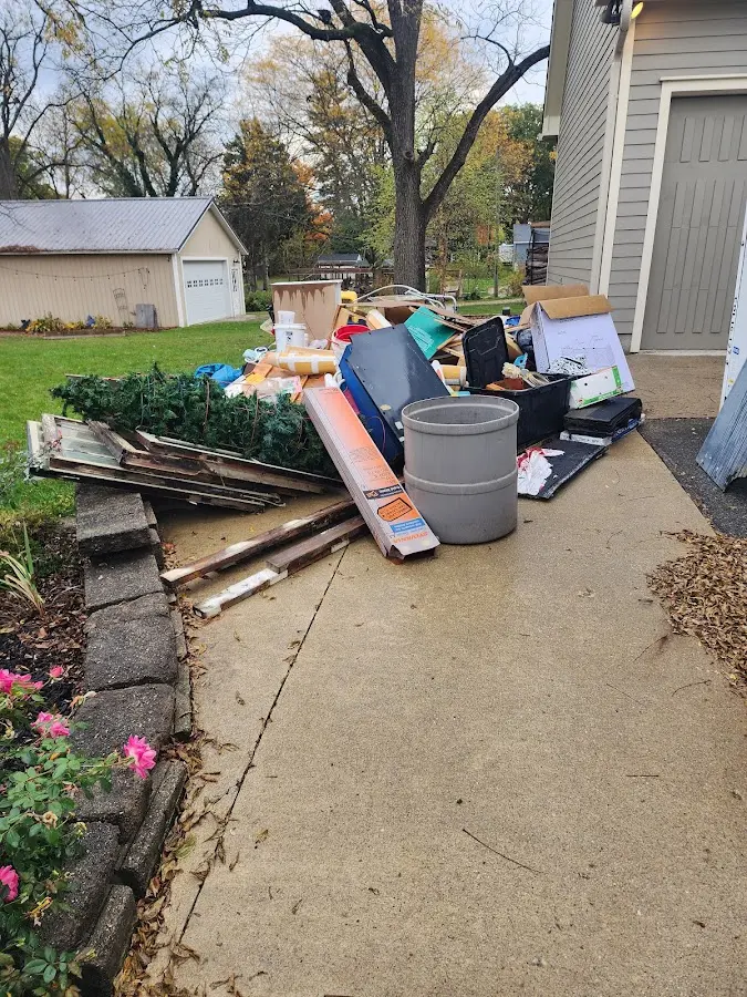 Dumpster being loaded with debris for 12 Yard Dumpster Rental in Scranton